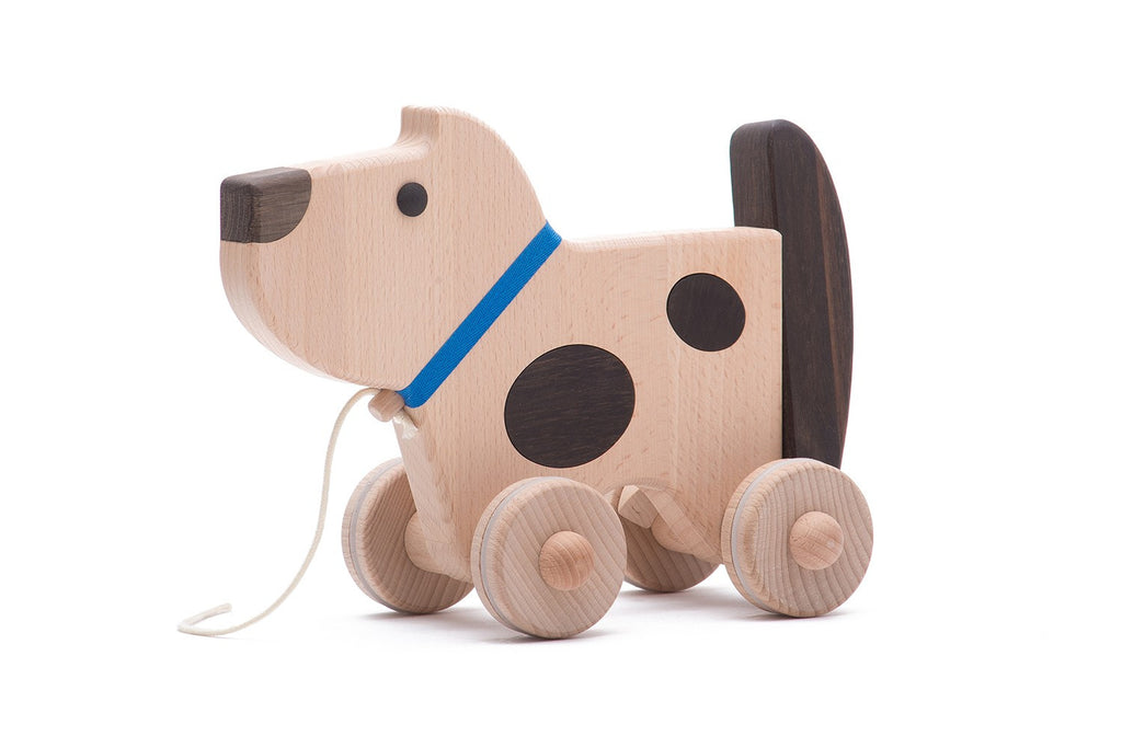 Wooden dog on wheels (wags its tail)