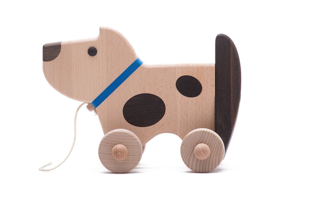 Wooden dog on wheels (wags its tail)
