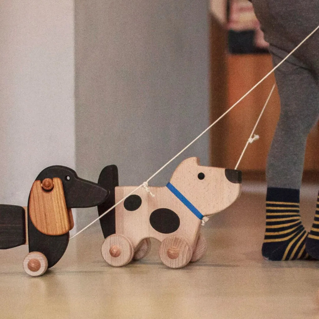 Wooden dog on wheels (wags its tail)