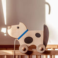 Wooden dog on wheels (wags its tail)